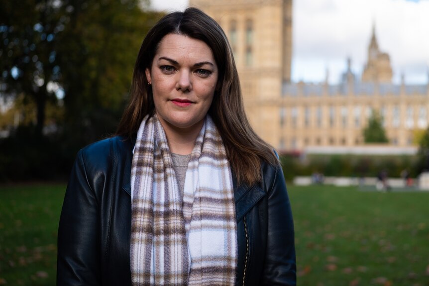 Senator Sarah Hanson-Young poses in front of the Houses of Parliament in London.