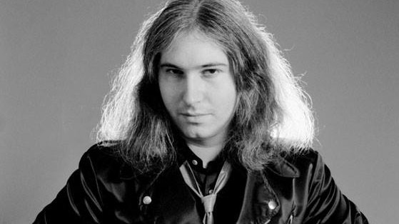 A young Jim Steinman looks at the camera while wearing a leather jacket.
