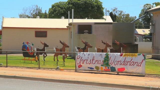 Large wooden Santa and reindeer display on lawn