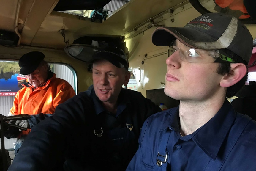 21 year-old trainee Brock Sutton works closely with the fireman and driver on his 4th week on the job.