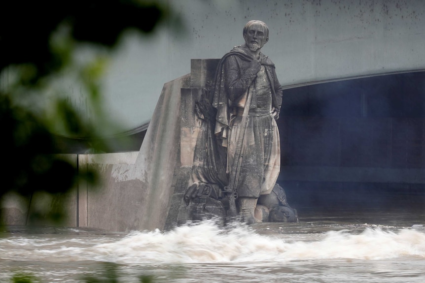 The Zouave statue's feet are covered by flood waters.