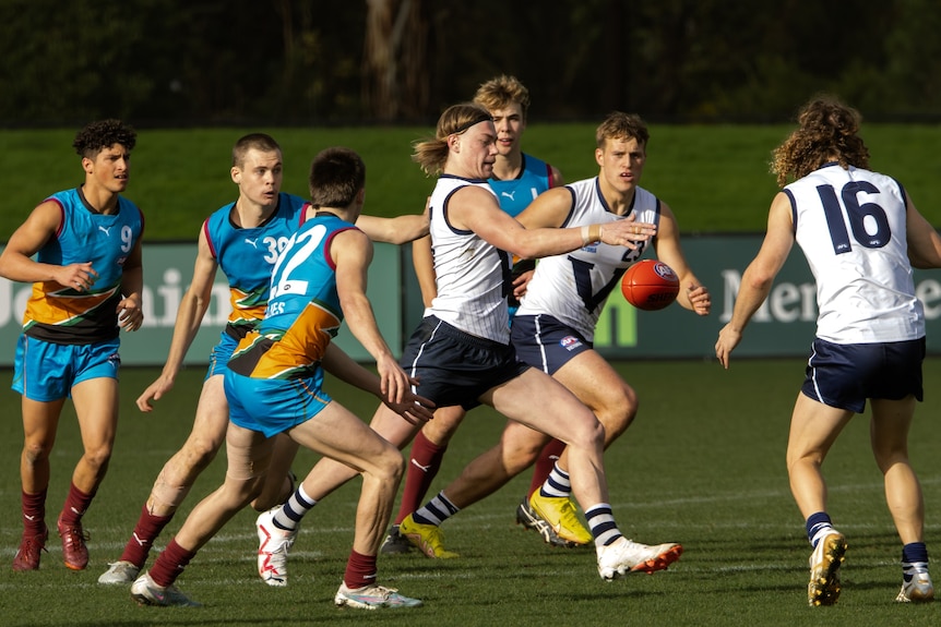 Harley Reid gets his kick away for Vic Country after bursting through the midfield.