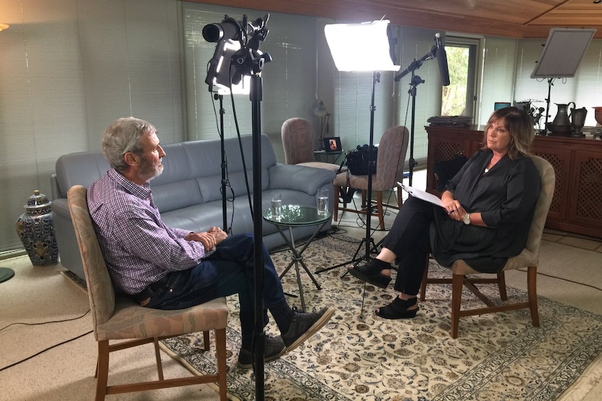 Don Burke crosses his legs as he sits in his home and is interviewed by A Current Affair reporter Tracey Grimshaw.
