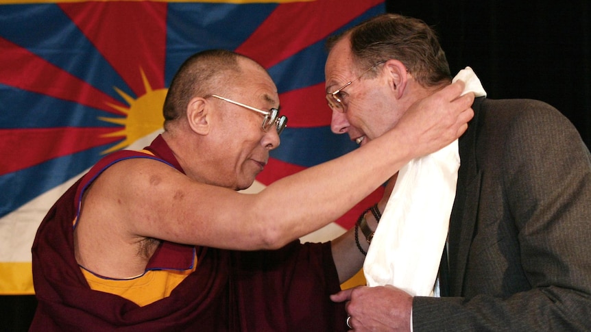 The Dalai Lama presents Bob Brown with a silk shawl.