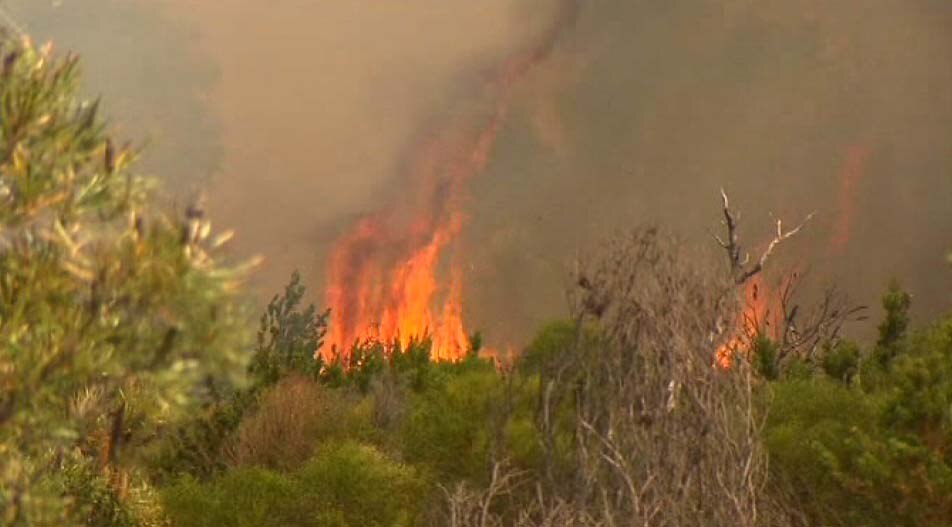 A bushfire burning in Perth's southern suburbs has been downgraded ...