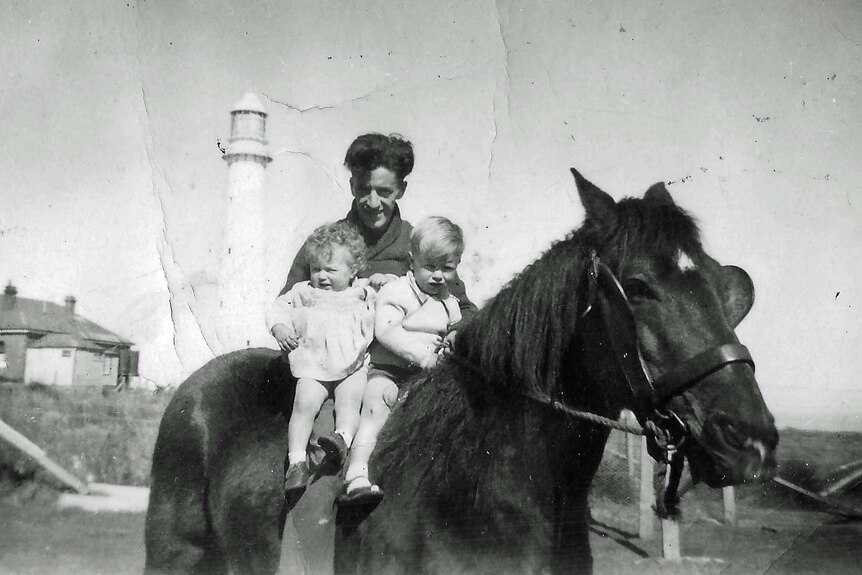 Carol Jackson with her father, the lighthouse keeper and her brother on the Tasman Island horse.
