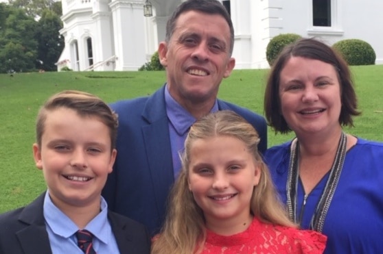 Darren Bullock his wife Donna and twins Alex and Abigail, who holds a bunch of roses.