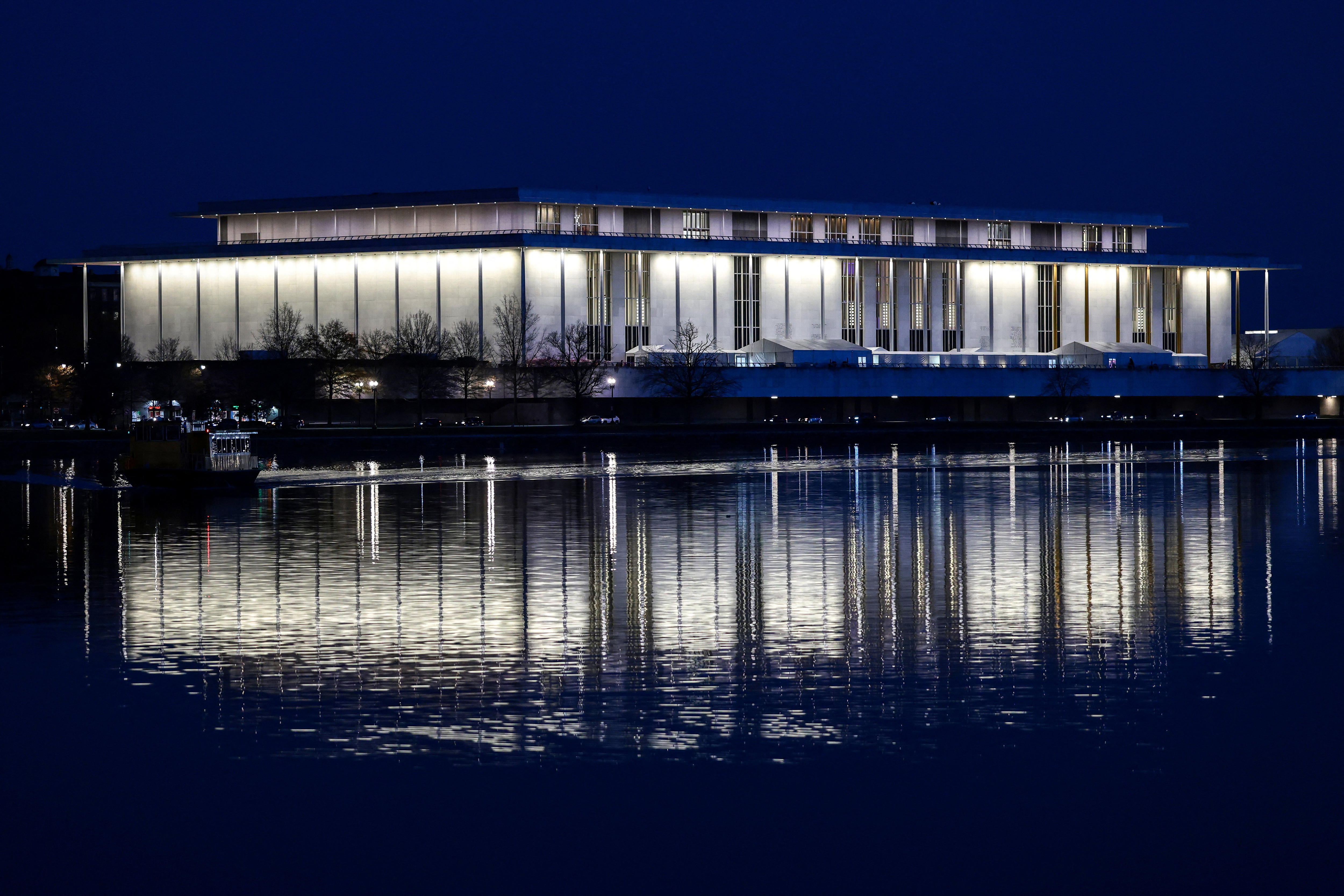 A building reflected by lights on the river.