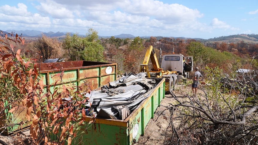 A large skip filled with metal sheets