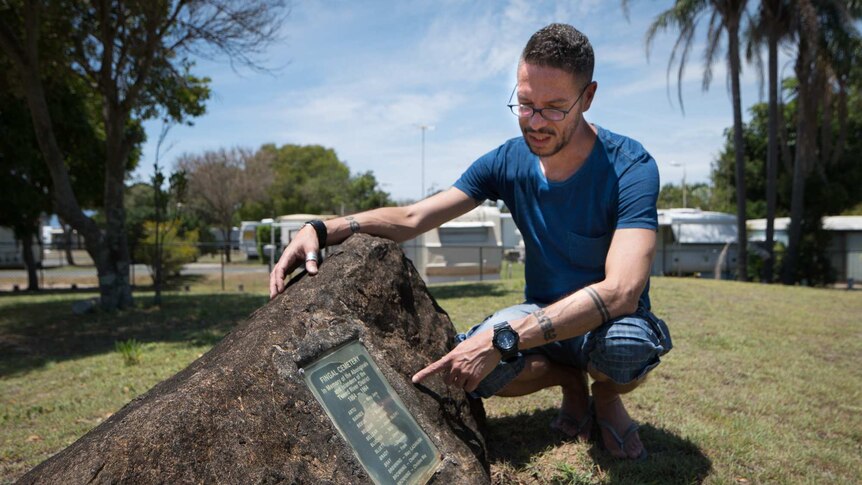 Daniel Browning pointing to the names of known Aboriginal people buried at the Fingal Cemetery