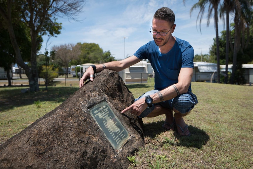 Daniel Browning pointing to the names of known Aboriginal people buried at the Fingal Cemetery
