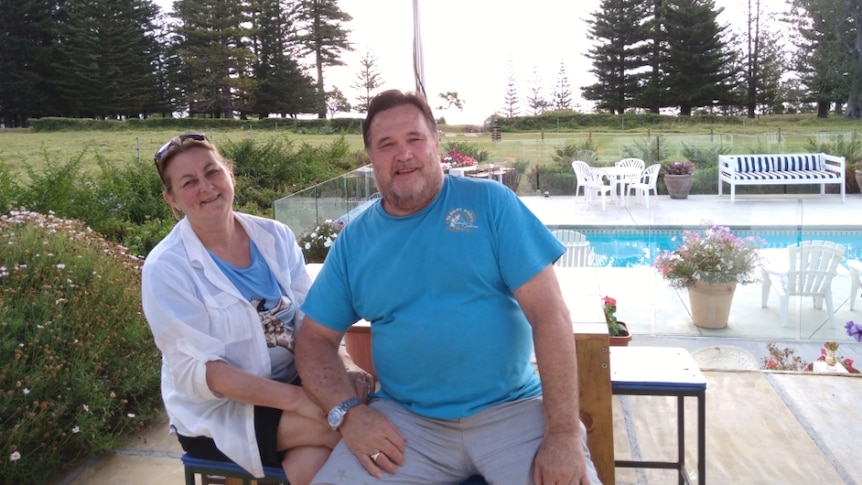 a woman and a man look happy by the pool