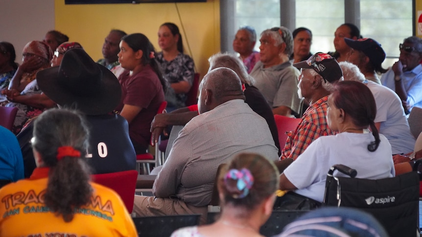 a room of aboriginal people sitting in chairs