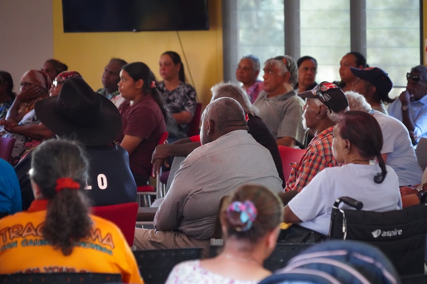 a room of aboriginal people sitting in chairs