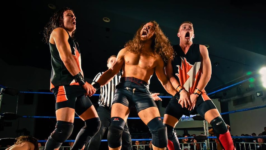 Three wrestlers and a referee in a ring at Melbourne City Wrestling.