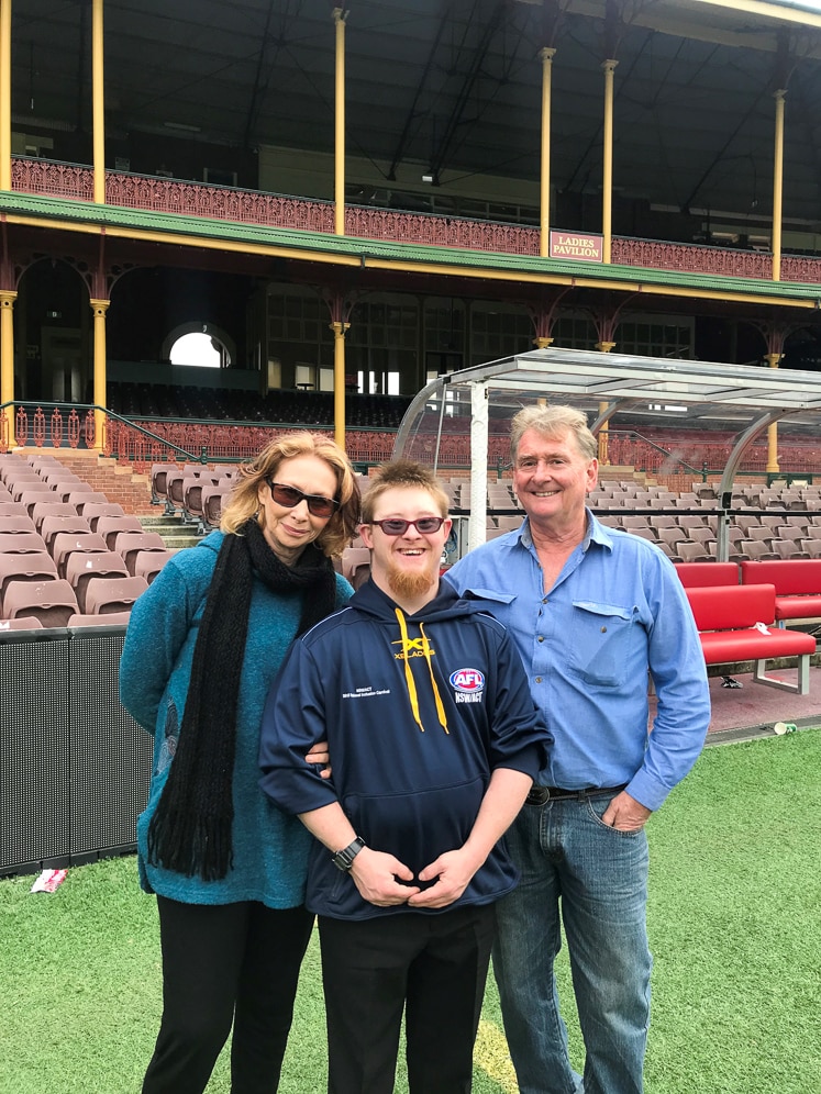 AFL Inclusion Carnival player Taylor Hanson with his parents at Sydney Cricket Ground.