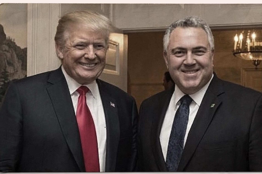 Mr Trump and Mr Hockey are both smiling. Mr Trump wears a red tie, while Mr Hockey wears blue.