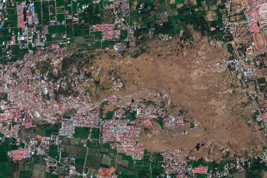 This October 1, 2018, satellite image provided by DigitalGlobe shows the Petobo neighborhood in Palu, Indonesia, after an earthquake and subsequent tsunami caused substantial damage and liquefaction in the village.