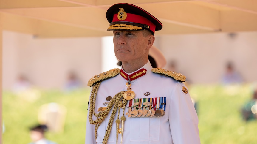 Defence chief in formal white military uniform