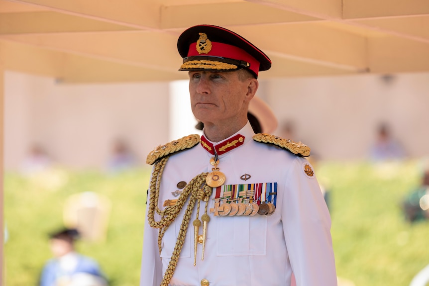 Defence chief in formal white military uniform