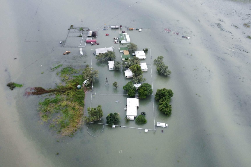 a drone shot of water surrounding a station homestead.