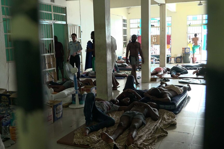 Downstairs in Jakarta's detention centre, immigration violators lie wherever they can find a spot.