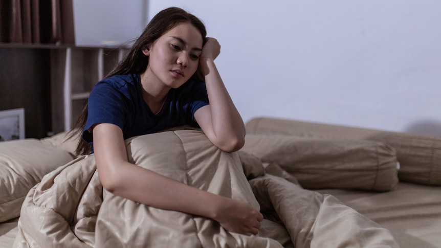 Woman struggling to sleep in bed at night