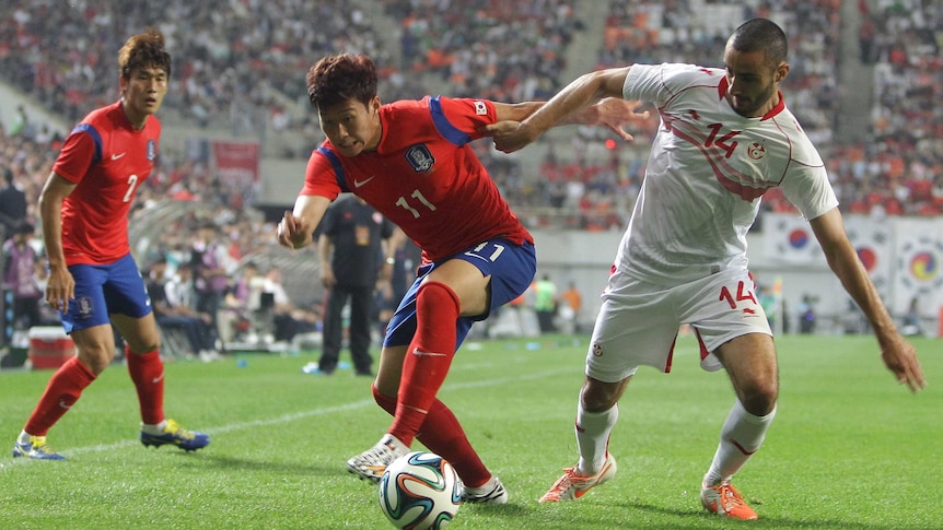 Song Heung-min battles for the ball against Tunisia