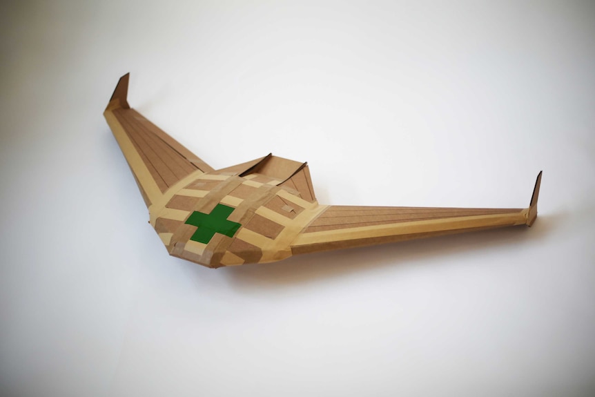 A small disposable cardboard glider, designed to help deliver aid.