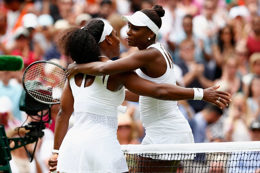 Serena Williams hugs her sister Venus after their fourth round match at Wimbledon