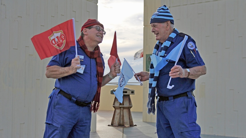 State of Origin rivals John McGovern and Allen Drochmann fly their flags at the state border