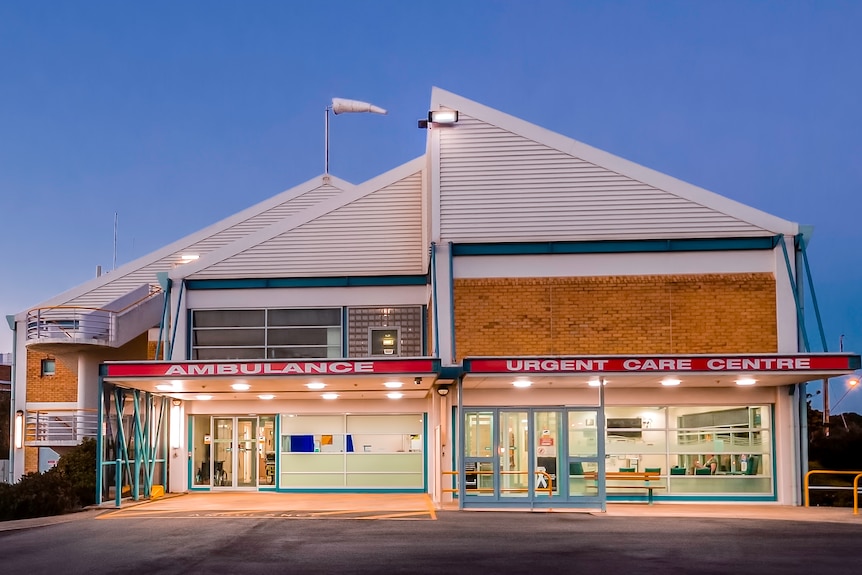 A small orange brick hospital building taken from the front