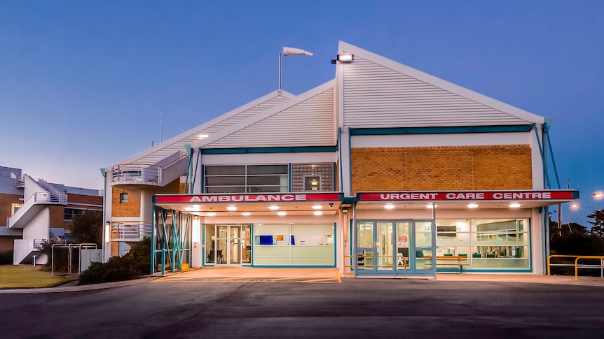 A small orange brick hospital building taken from the front