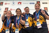 South Australian swimmers with their gold medals on the podium at the Special Olympics.