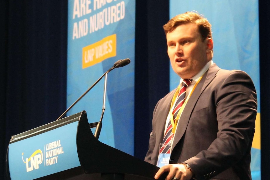 LNP party president David Hutchinson speaks at lectern.