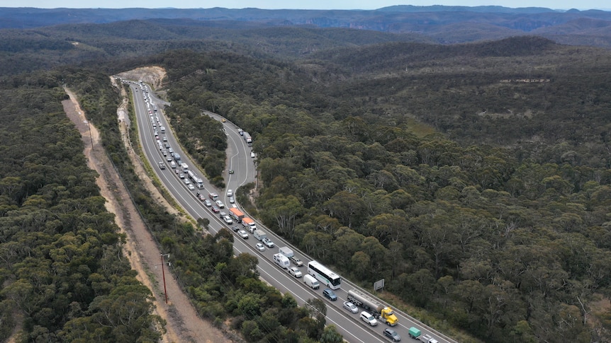 Traffic banked up with a line of cars and trucks stretching into the distance