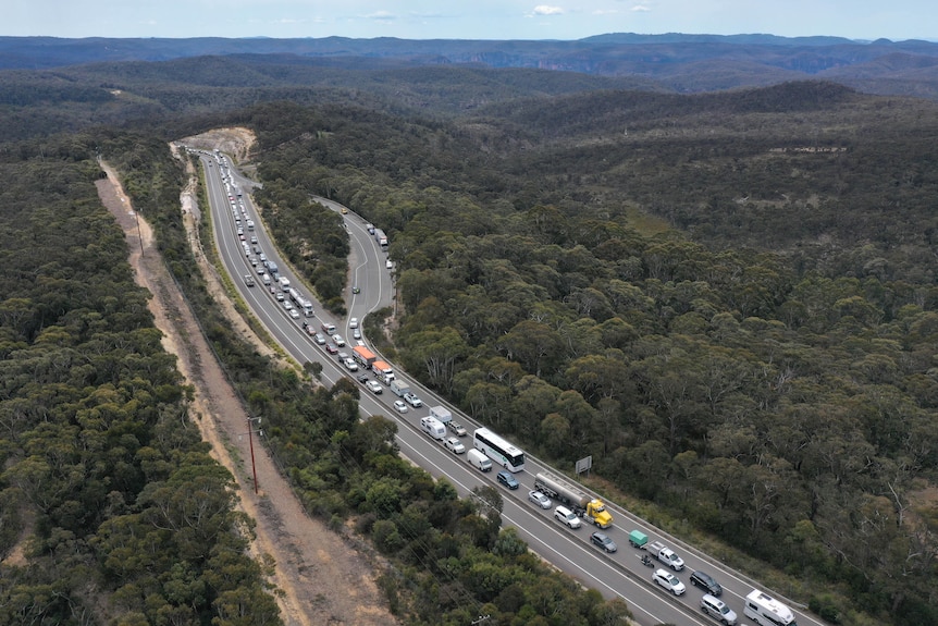 Traffic banked up with a line of cars and trucks stretching into the distance