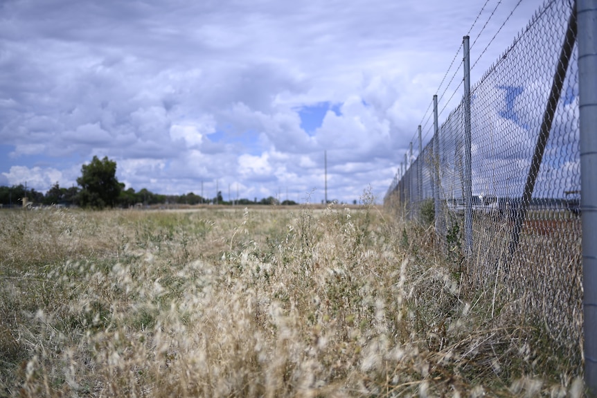 A fence next to a field