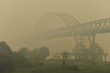 Kahayan bridge is seen through thick yellow haze in Palangkaraya