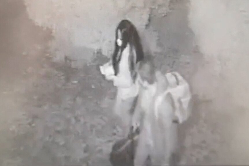 Black and white cctv of a man and woman