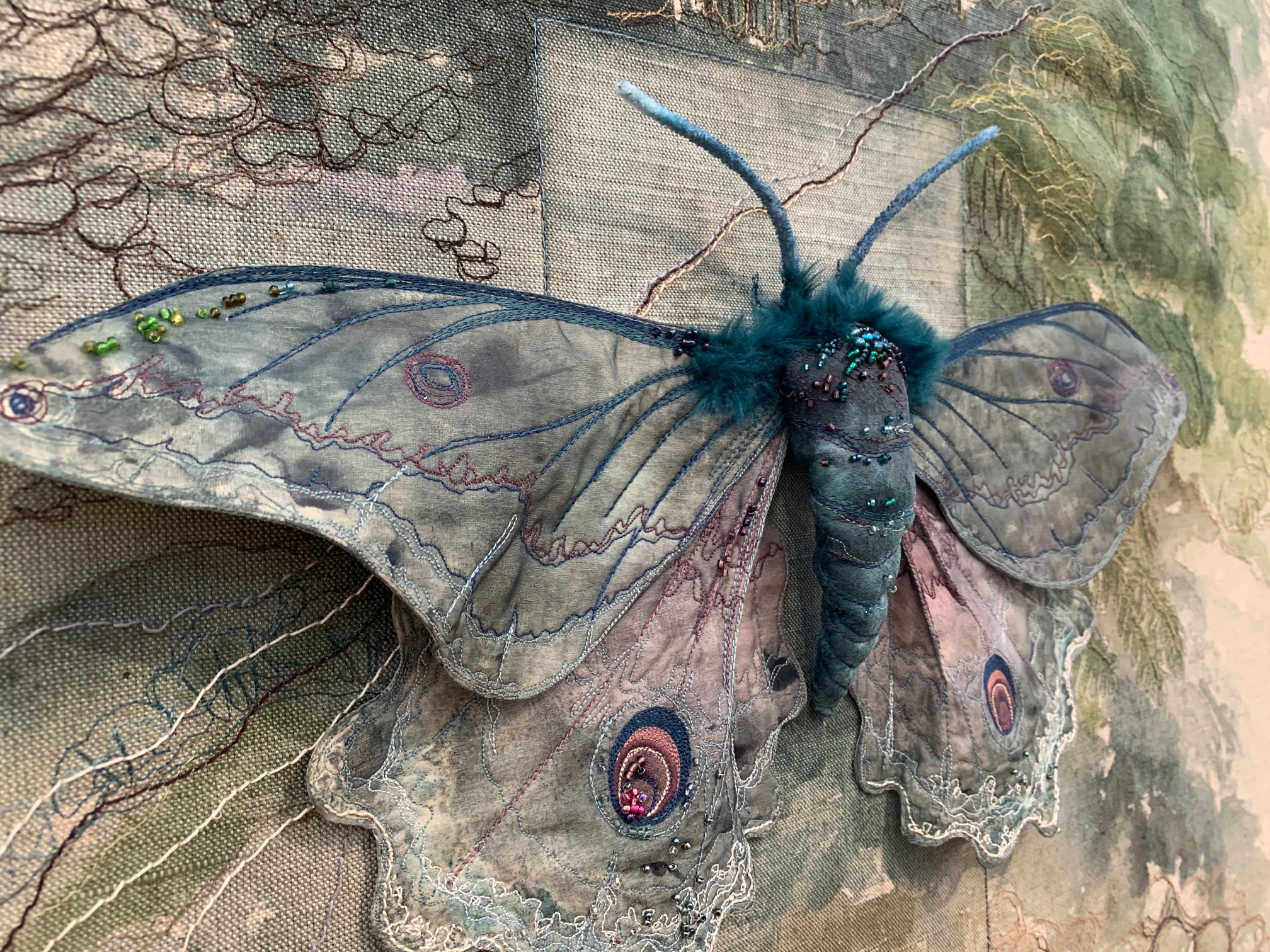 painted moth figure with machine stiching  