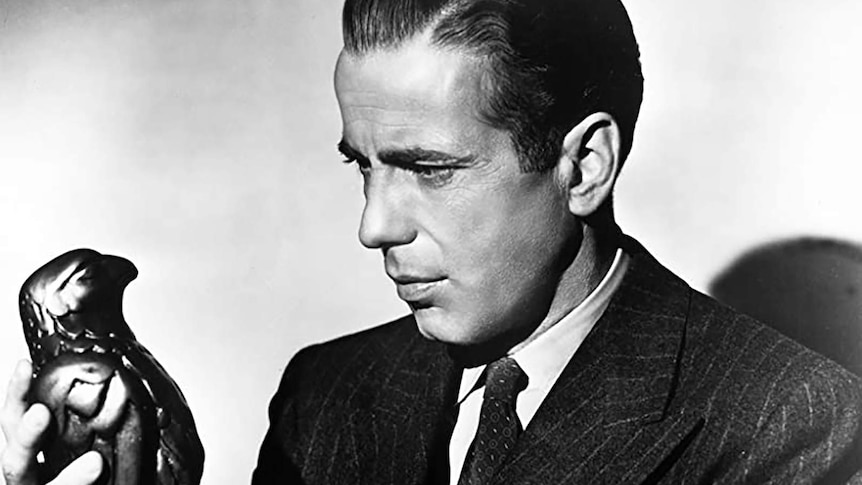Humphrey Bogart stares at the maltese falcon
