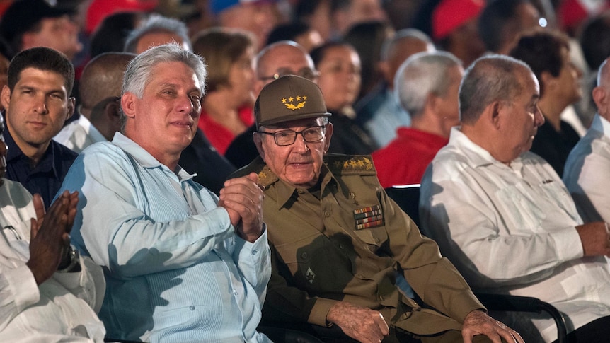 Castro and Diaz-Canel sitting in an audience together.