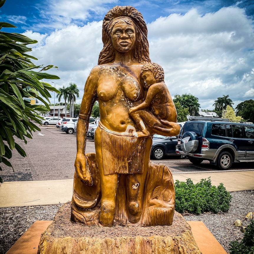 Statue in a carpark of Aboriginal woman carrying a child.