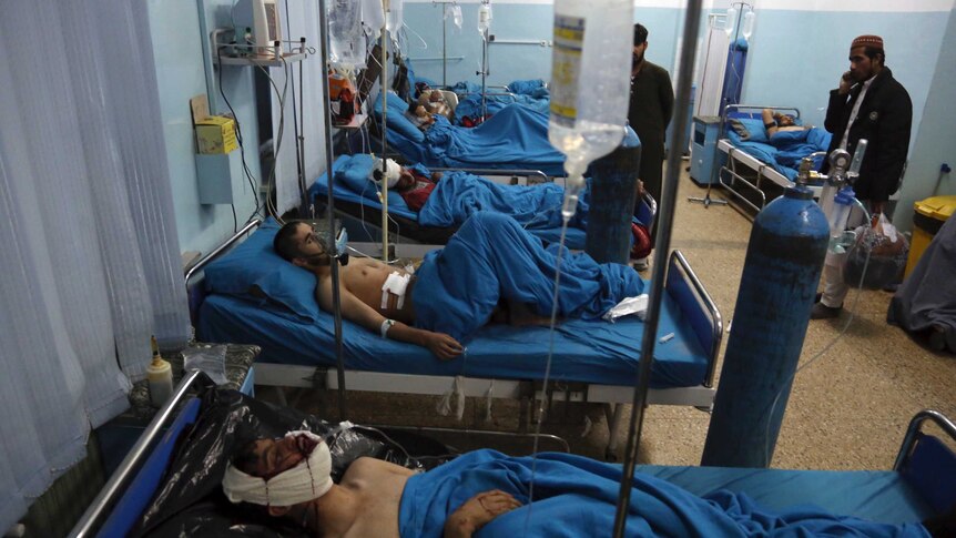 Injured men receive treatment at a hospital after a suicide bombing in Kabul, Afghanistan.