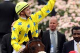 A special day: Christophe Lemaire salutes the crowd after riding Dunaden to glory. (AAP: Joe Castro)