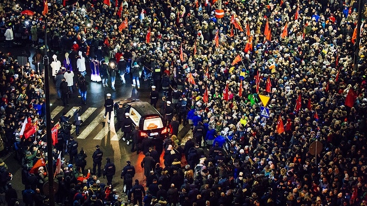 Tens of thousands of people took part in a procession following the coffin of Mr Adamowicz.