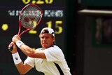 Lleyton Hewitt returns a shot on the way to his 100th win on grass.