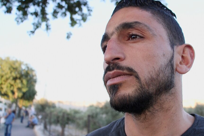 Ahmad, 25, has to spend hours each day passing through a West Bank checkpoint in order to get to work in Jerusalem.
