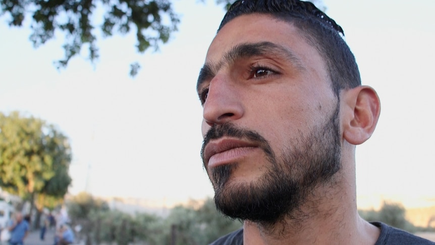 Ahmad, 25, has to spend hours each day passing through a West Bank checkpoint in order to get to work in Jerusalem.